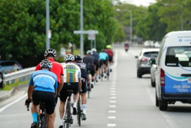 a group of people riding bikes down a street