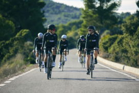 a group of people riding bikes down a road