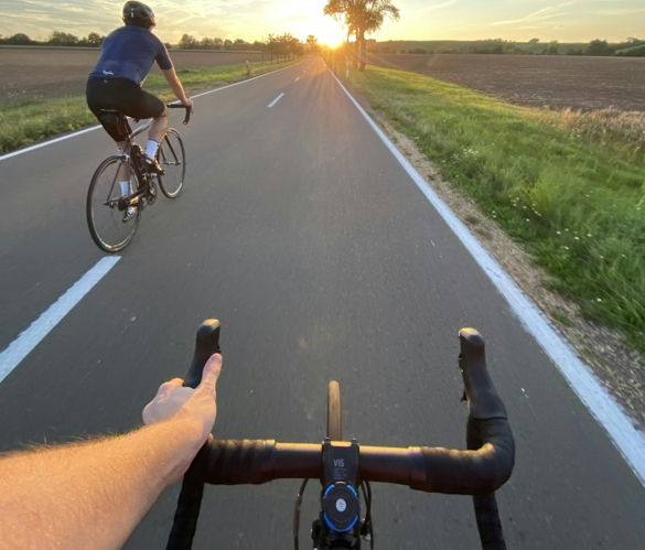 man in black shirt riding bicycle on road during daytime